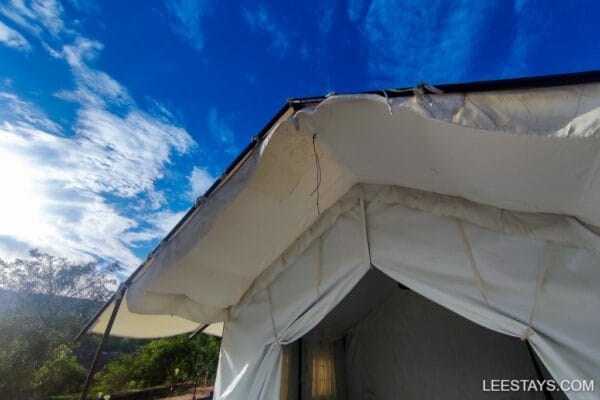 A close-up view of a glamping setup with a pristine sky over Pawna Lake, showcasing modern outdoor luxury.